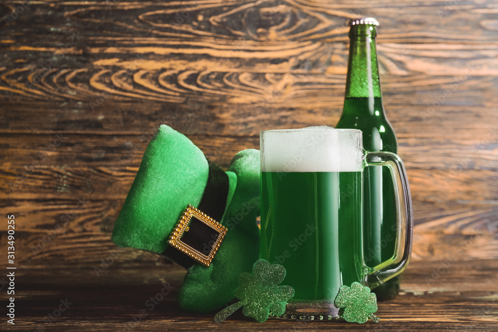 Composition with green beer for St. Patrick's Day on wooden table