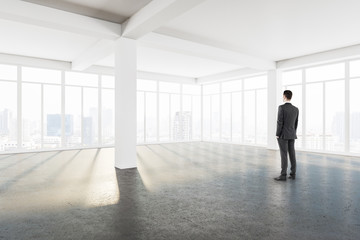 Sticker - Young businessman standing in modern interior