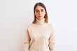 © Krakenimages.com - Beautiful redhead woman wearing winter turtleneck sweater over isolated background Relaxed with serious expression on face. Simple and natural looking at the camera.