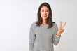 © Krakenimages.com - Young beautiful chinese woman wearing striped t-shirt standing over isolated white background showing and pointing up with fingers number two while smiling confident and happy.