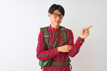 Wall Mural - Chinese hiker man wearing backpack canteen glasses over isolated white background with a big smile on face, pointing with hand and finger to the side looking at the camera.