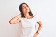 Young beautiful woman wearing casual t-shirt standing over isolated white background Suffering of neck ache injury, touching neck with hand, muscular pain
