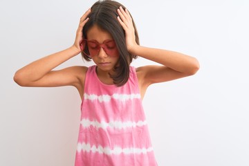 Sticker - Young beautiful child girl wearing pink t-shirt and sunglasses over isolated white background suffering from headache desperate and stressed because pain and migraine. Hands on head.