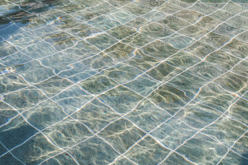 blue swimming pool sun reflection in clear clean and bright blue water of swimming pool, shining blu