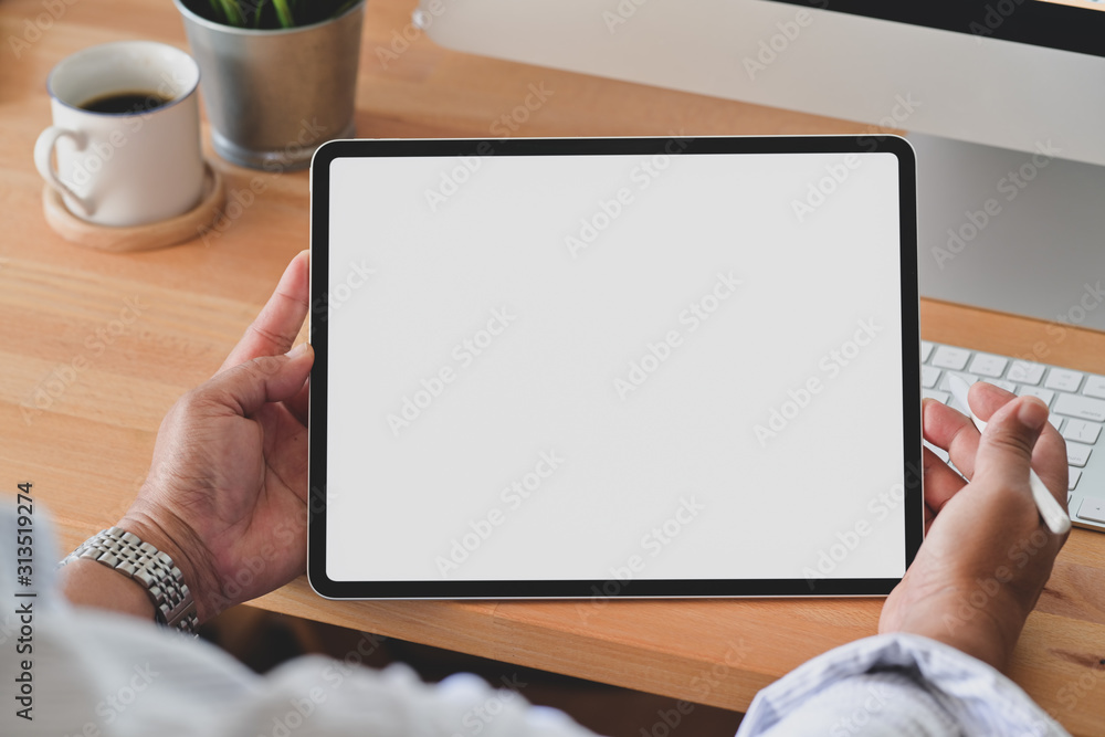 Cropped shot of young man holding blank screen digital tablet - obrazy, fototapety, plakaty 