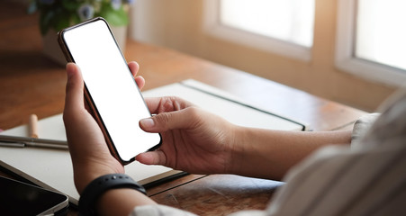 Wall Mural - cropped shot view of woman hands holding smart phone with blank copy space screen for your text mess