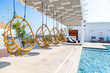Swing chair sides swimming pool on rooftop