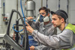 © vadimalekcandr - An employee of the paint shop of the automobile plant conducts training on applying sealant