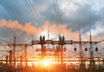 The silhouette of the evening electricity transmission pylon. Power transmission from a power plant to a city.