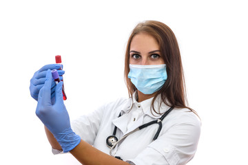 Doctor in mask examining test tubes with red substance isolated on white