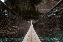Low Angle View Of Suspension Bridge Over Rapid River