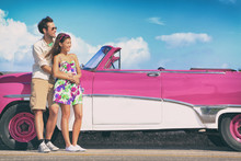 Couple Driving Pink Vintage Car On Summer Road Trip Travel Fun.
