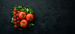 Fresh red tomatoes on a dark background. Vegetables. Top view. Free space for your text.