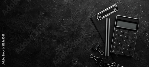 Fotografía Calculator and office tools on a stone black desk