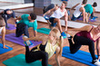 © JackF - Young positive people stretching in dance hall