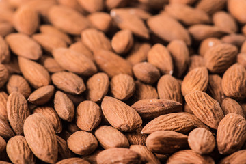 Almonds nut on white wooden table. Almond healthy raw food background.