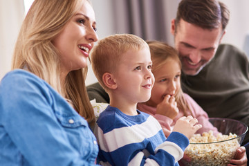 Wall Mural - Close up of family watching tv at home