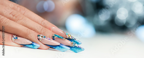 Winter nail art polish, Nails gel technique, Sparkling blue colour background, R Fototapet