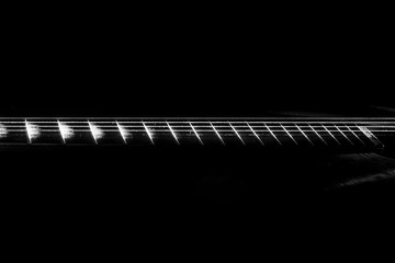 The tuning end of a guitar isolated on a black background.