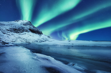 Canvas Print - Aurora Borealis, Lofoten islands, Norway. Winter landscape in the night time during polar lights. Nothen light, mountain and frozen water. Norway - image