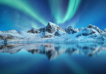 Wall Mural - Aurora Borealis, Lofoten islands, Norway. Northen lights, mountains and reflection on the water. Winter landscape during polar lights. Norway travel - image