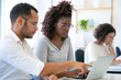 © Mangostar - Thoughtful African American employees working with laptop. Side view of focused young woman typing on laptop at office. Technology concept