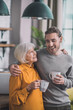 © zinkevych - Young handsome man in grey shirt and his mom feeling wonderful together