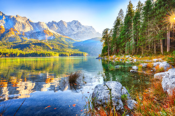 Wall Mural - faboulus autumn landscape of eibsee lake in front of zugspitze summit under sunlight