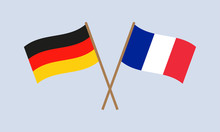 Germany And France Crossed Flags On Stick. German And French National Symbols. Vector Illustration.