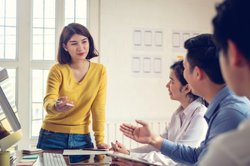 Wall Mural - group of young asian designers drawing website ux app development on mobile phone.