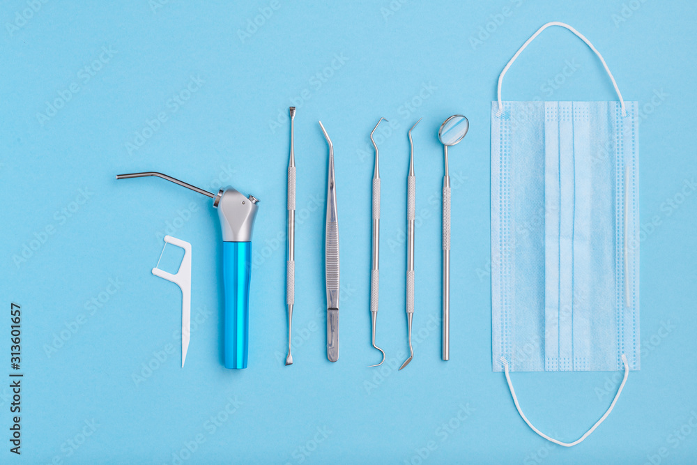Dentist tools over blue background top view - obrazy, fototapety, plakaty 
