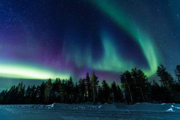 northern lights aurora borealis activity over the road in finland, lapland