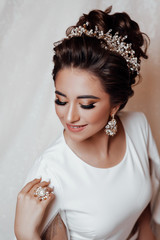  Morning preparation before wedding ceremony. Sexy girl. Portrait of beautiful bride. Wedding dress. Beautiful sensual brunnete with elegant hairstyle. Wedding accessories. Fashion photo