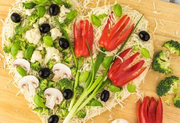 Wall Mural - Vegetarian heart shaped pizza for Valentine Day.