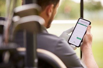 Close Up Of Male Golfer In Buggy Checking Score On Mobile Phone App