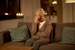 © Syda Productions - pain, stress and people concept - unhappy senior woman suffering from headache at home at night
