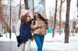 © Andrey_Arkusha - Close up portrait of two young girls walking in a winter park