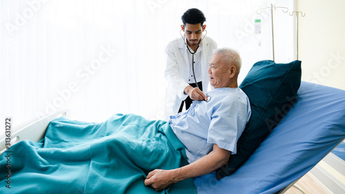 Senior Asian patients lying hospital bed, receiving medical treatment from specialist doctor. Physical examination Such as respiratory system, heartbeat, diabetes and pressure. Concept life insurance