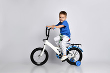 Young Boy Happily Riding On A Bicycle On Isolated Background