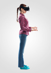 Wall Mural - Young woman wearing VR goggles