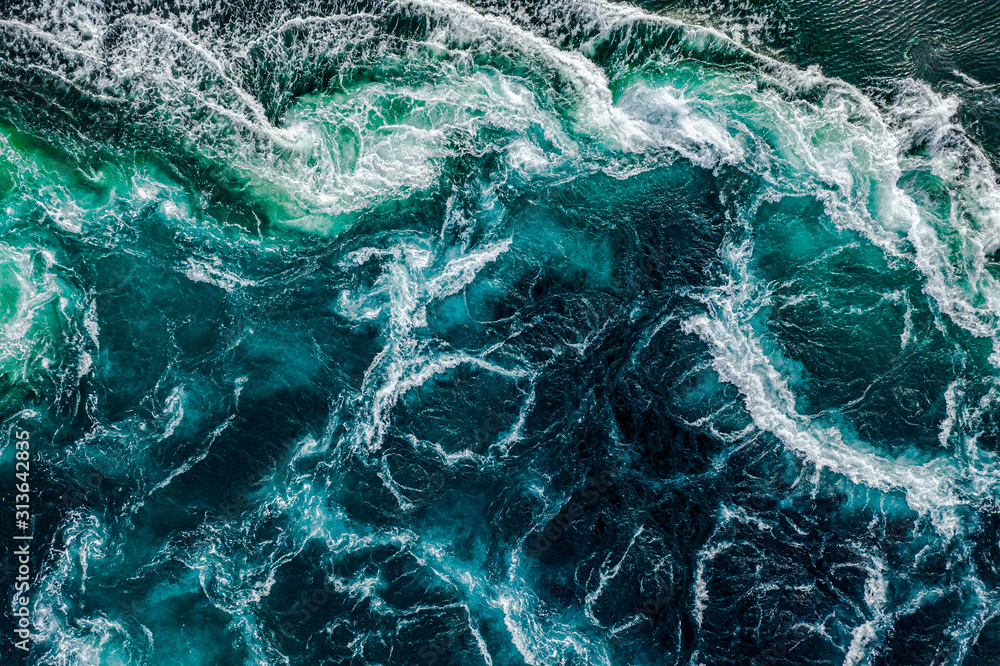 Abstract background. Waves of water of the river and the sea meet each other during high tide and low tide. Whirlpools of the maelstrom of Saltstraumen, Nordland, Norway - obrazy, fototapety, plakaty 