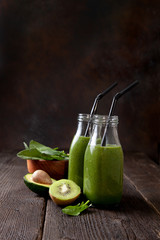 Poster - spinach smoothie in glass bottles