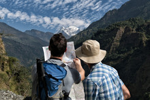 Two Hikers Reading Map At Muri, Dhaulagiri Circuit Trek, Himalaya, Nepal