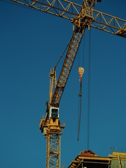 yellow construction crane on blue sky