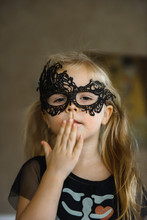 Little Smiling Girl In Mask Dressed For Halloween In Skeleton Costume