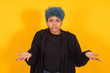 © carballo - young african american girl or woman with blue hair isolated on yellow background