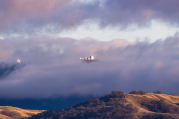 Wall Mural - Storm clouds covering the top of Mount Hamilton, with Lick Observatory peeking through them; San Jose, South San Francisco Bay Area, California