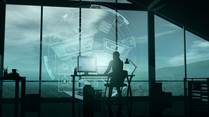 A web developer at a computer in her office and virtual infographics.