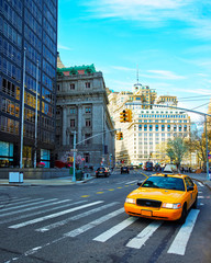 Wall Mural - Yellow taxi on road. Street view in Financial District of Lower Manhattan, New York of USA. Skyline and cityscape with skyscrapers at United States of America, NYC, US. American architecture.