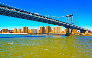 Wall Mural - Manhattan bridge across East River, New York, USA. It is among the oldest in the United States of America. NYC, US. Skyline and cityscape. American construction